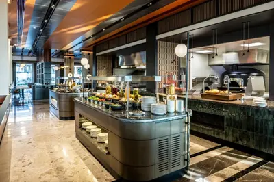 a restaurant with a buffet line with food at GOLDEN TULIP GEBKIM KOCAELI in Kocaeli