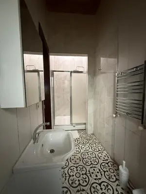 a bathroom with a sink and a toilet and a window at Grand Bedir in Istanbul