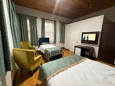 a hotel room with two beds and a flat screen tv at Grand Bedir in Istanbul