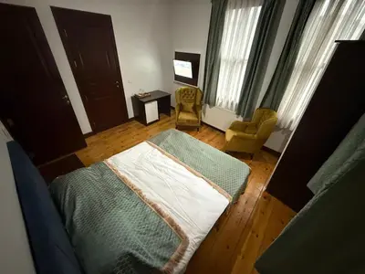 a bedroom with a bed and a chair at Grand Bedir in Istanbul