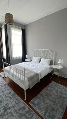 a bedroom with a white bed and two tables at DESTA Turizm in Istanbul