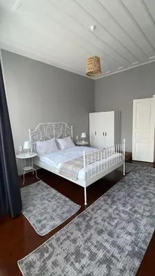 a bedroom with a white bed and a rug at DESTA Turizm in Istanbul