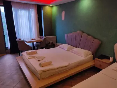 a small bedroom with a bed and a table at AG Hotel & Residence Şişli in Istanbul