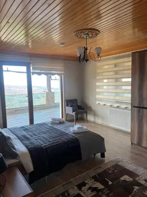a bedroom with a bed and a wooden ceiling at Montana butik pansiyon in Sapanca