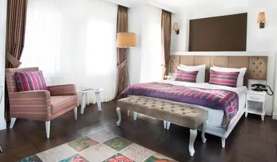 a hotel room with a bed and a chair at Astan Hotel Taksim in Istanbul