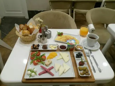 a white table with a tray of food on it at Astan Hotel Taksim in Istanbul