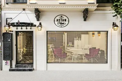 a restaurant with purple chairs in a window at Astan Hotel Taksim in Istanbul