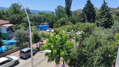 a street light with cars parked in a parking lot at İznik Seyir Otel in İznik