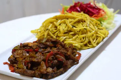 a plate of food with pasta and a salad at İznik Seyir Otel in İznik