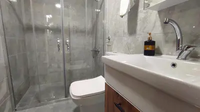 a bathroom with a shower and a toilet and a sink at İznik Seyir Otel in İznik