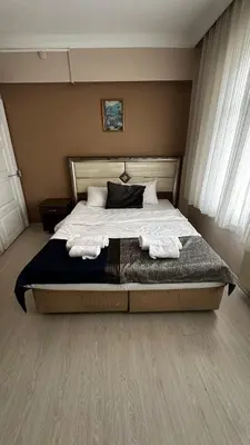 a bedroom with a large bed with towels on it at Sultana Premier Hotel in Istanbul