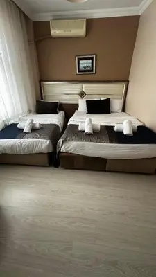 a bedroom with two beds with white towels on them at Sultana Premier Hotel in Istanbul