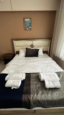 a bedroom with a bed with two towels on it at Sultana Premier Hotel in Istanbul
