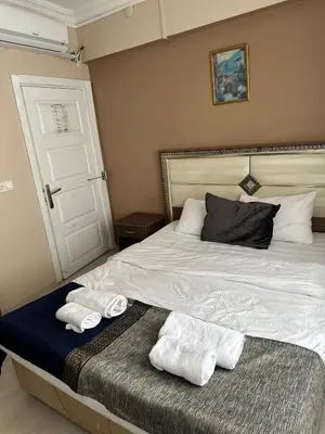 a bedroom with a bed with two towels on it at Sultana Premier Hotel in Istanbul