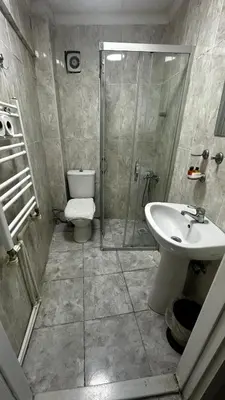 a bathroom with a shower and a toilet and a sink at Sultana Premier Hotel in Istanbul