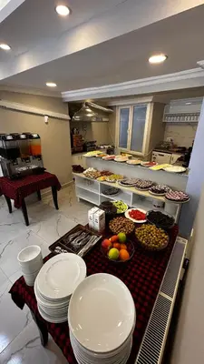 a kitchen with plates and food on a table at Sultana Premier Hotel in Istanbul
