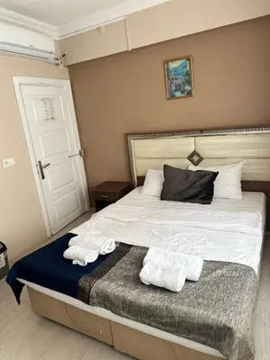 a bedroom with a bed with two towels on it at Sultana Premier Hotel in Istanbul