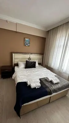 a bedroom with a large bed with towels on it at Sultana Premier Hotel in Istanbul