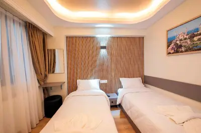 a hotel room with two beds and a window at Mar Residence in Istanbul