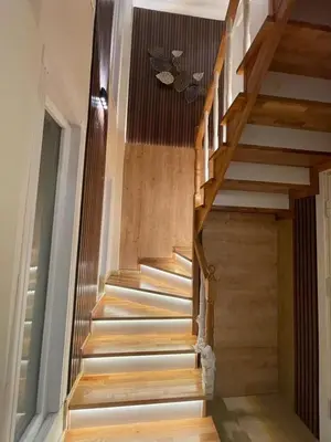 a wooden staircase in a house with wooden floors at Villa 7even By Luxury Group in Buyukcekmece