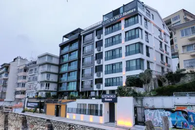 a tall white building with a sign on it at Elite World Homes Istanbul Bosphorus in Istanbul