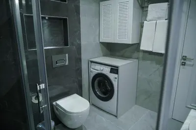 a bathroom with a washing machine and a toilet at Elite World Homes Istanbul Bosphorus in Istanbul