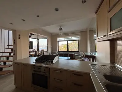 a kitchen with an island and a living room at Heavenly Peace Stunning View Terrace Jacuzzi in Istanbul