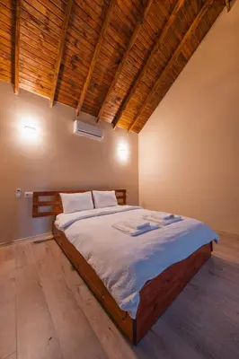 a bedroom with a large bed in a room at Varuna Bungalov Evleri in Sapanca