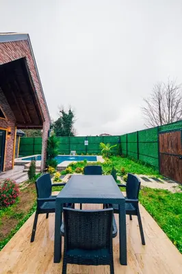 a blue table and chairs in a yard at Varuna Bungalov Evleri in Sapanca