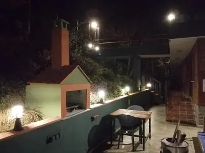 a patio with a table and chairs at night at Nerry's Garden Izmit - Rose in Yukarı Mecidiye