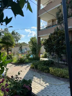 a garden outside a building with a hose at Nerry's Garden Izmit - Rose in Yukarı Mecidiye