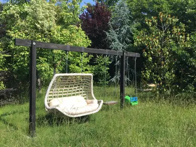 a swinging chair in the grass in a field at Nerry's Garden İzmit - Camellia in Izmit