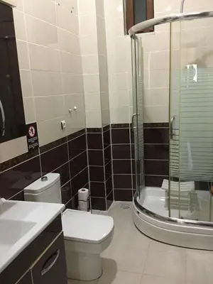 a bathroom with a toilet and a glass shower at Nerry's Garden İzmit - Camellia in Izmit