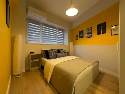 a bedroom with a bed and a yellow wall at Stunning 2BR 2Bath near Metro - YM 1 in Istanbul
