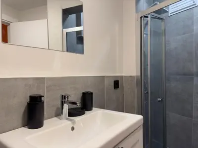 a bathroom with a white sink and a shower at Stunning 2BR 2Bath near Metro - YM 1 in Istanbul