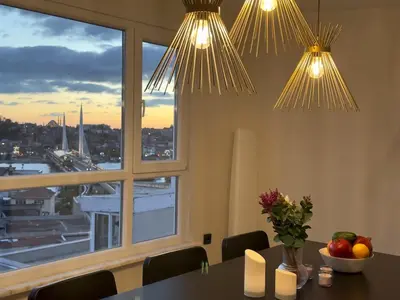 a dining room with a table and two lights at Stunning 2BR 2Bath near Metro - YM 1 in Istanbul