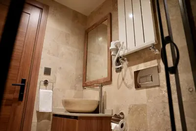 a bathroom with a sink and a mirror at Khalkedon Suites in Istanbul