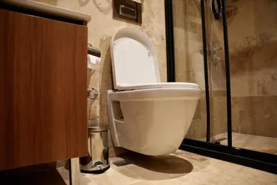 a white toilet in a bathroom with a shower at Khalkedon Suites in Istanbul