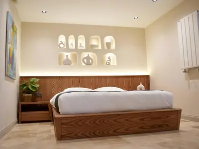 a bedroom with a wooden bed with plates on the wall at Khalkedon Suites in Istanbul