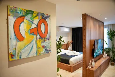 a bedroom with a painting on the wall next to a bed at Khalkedon Suites in Istanbul
