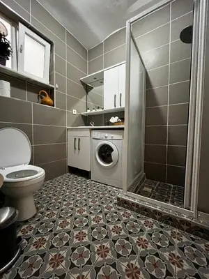 a bathroom with a toilet and a washing machine at Taksim Apartment in Istanbul