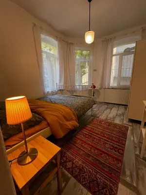 a bedroom with a bed and a table with a lamp at Taksim Apartment in Istanbul