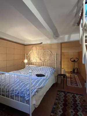 a bedroom with a bed with a metal headboard at Roza's Istanbul Homestay in Istanbul