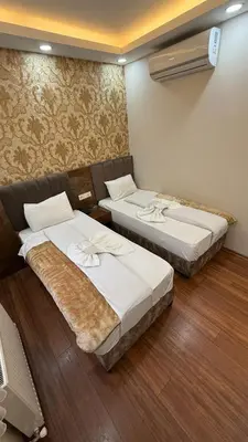 two beds sitting in a room with wood floors at Hotel FORTYNİNE in Istanbul