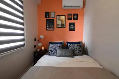a bed in a room with an orange wall at Stunning 2BR 3AC Near Metro - YM 3 in Istanbul