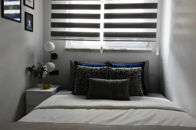 a bed in a bedroom with a window and pillows at Stunning Seaview 2BR near Metro - YM4 in Istanbul