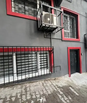 a building with red windows and a fan on it at Stunning Seaview 2BR near Metro - YM4 in Istanbul