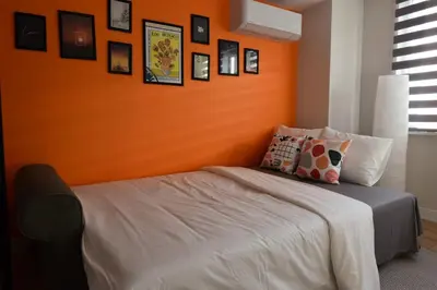 a bedroom with an orange wall and a bed at Stunning Seaview 2BR near Metro - YM5 in Istanbul
