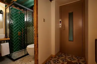 a bathroom with a toilet and a glass shower at Spacious 2BR w AC Lift in Taksim - Kurabiye D2 in Istanbul