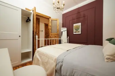 a bedroom with a bed and a chandelier at Spacious 2BR w AC Lift in Taksim - Kurabiye D2 in Istanbul